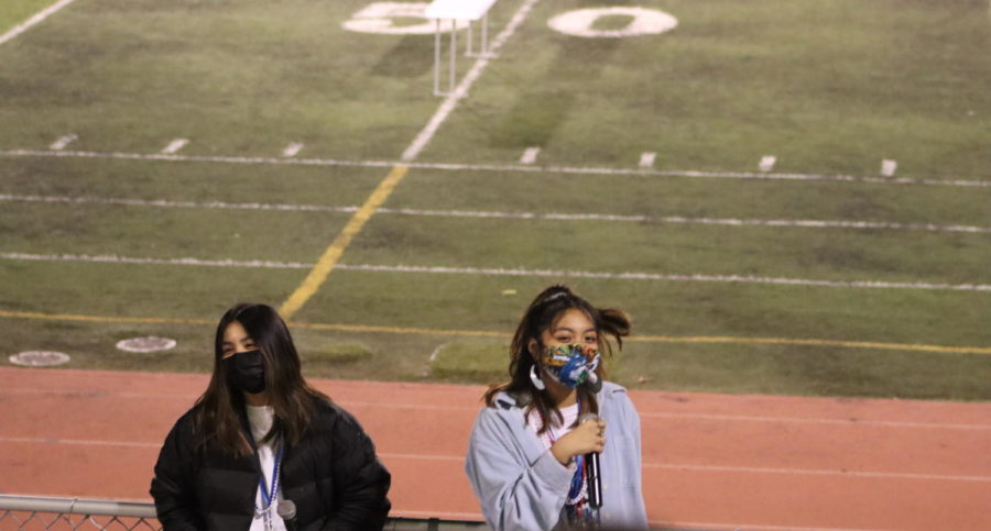 San Leandro High School seniors Lexi Bayot and Alyssa Santos get the crowd ready for the rally at Burrell Field. 