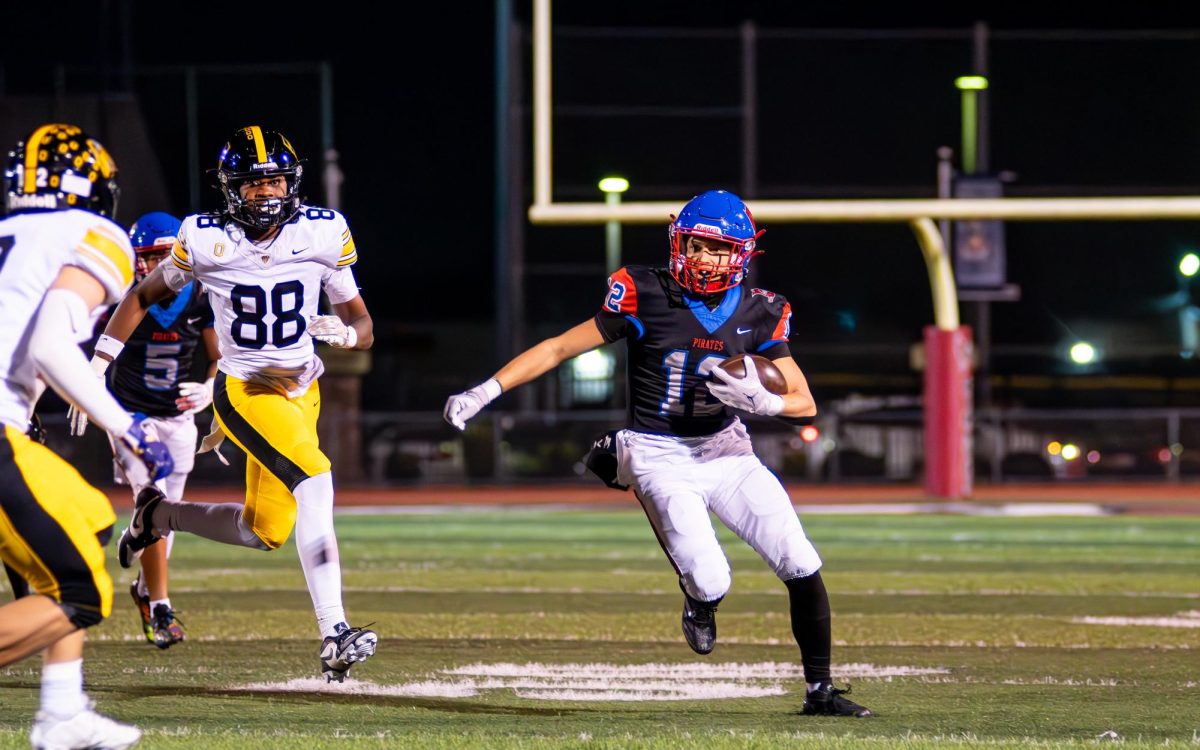 TOUCHDOWN! Quarterback Nicholas Chavez runs with the football in possession as players from Bishop O'Dowd chase him down. 